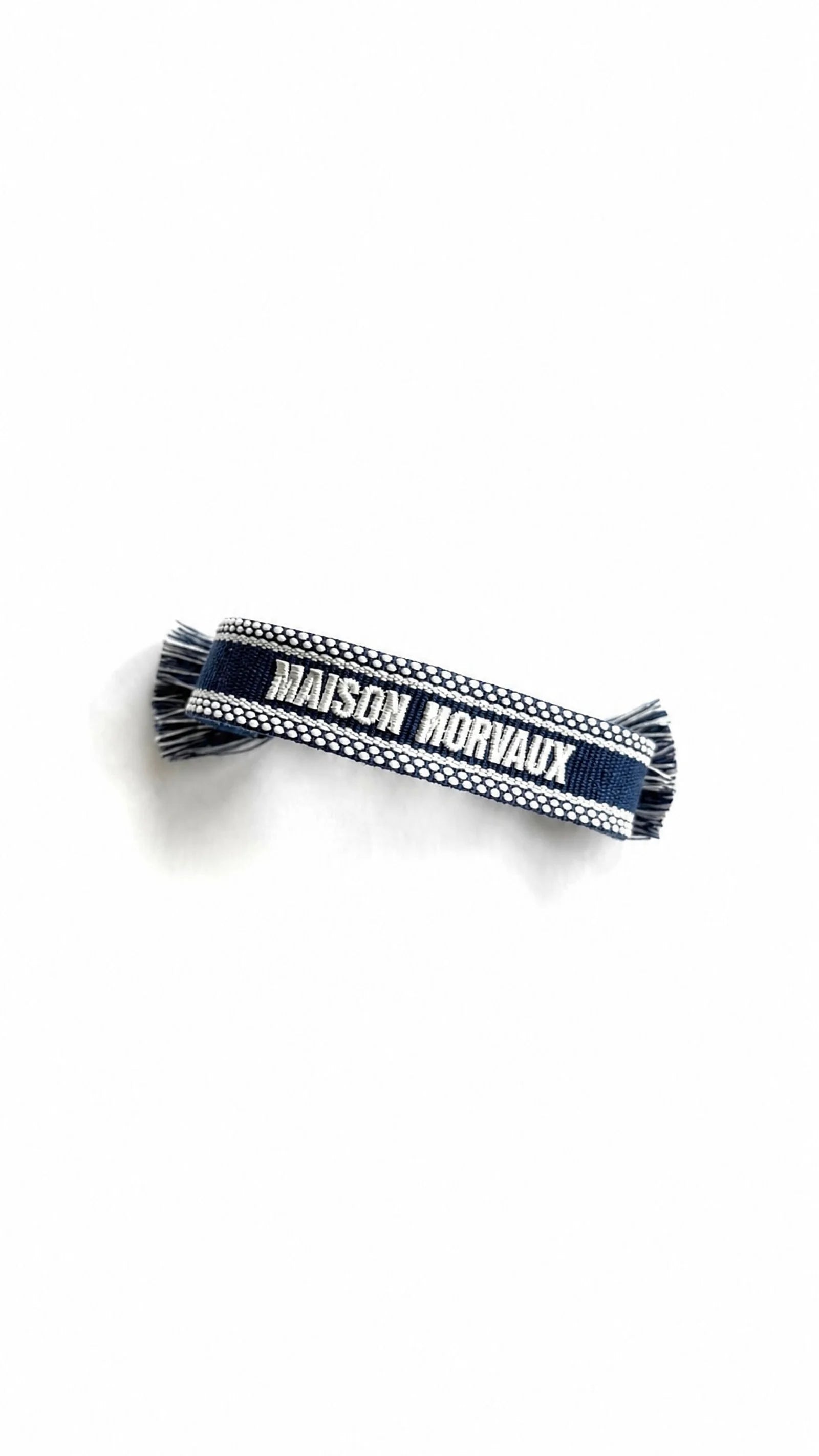 Maison Band from above, showing the woven pattern and fringed ends
