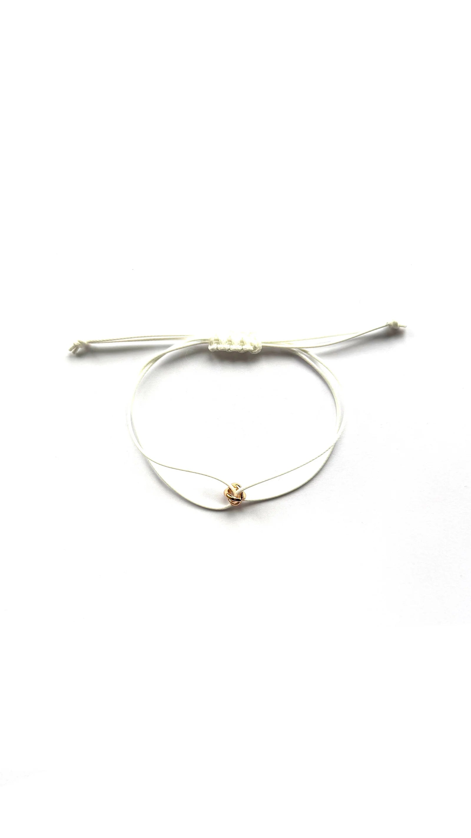 ORÉA Blanc, ivory-white cord bracelet with a single gold-plated bead