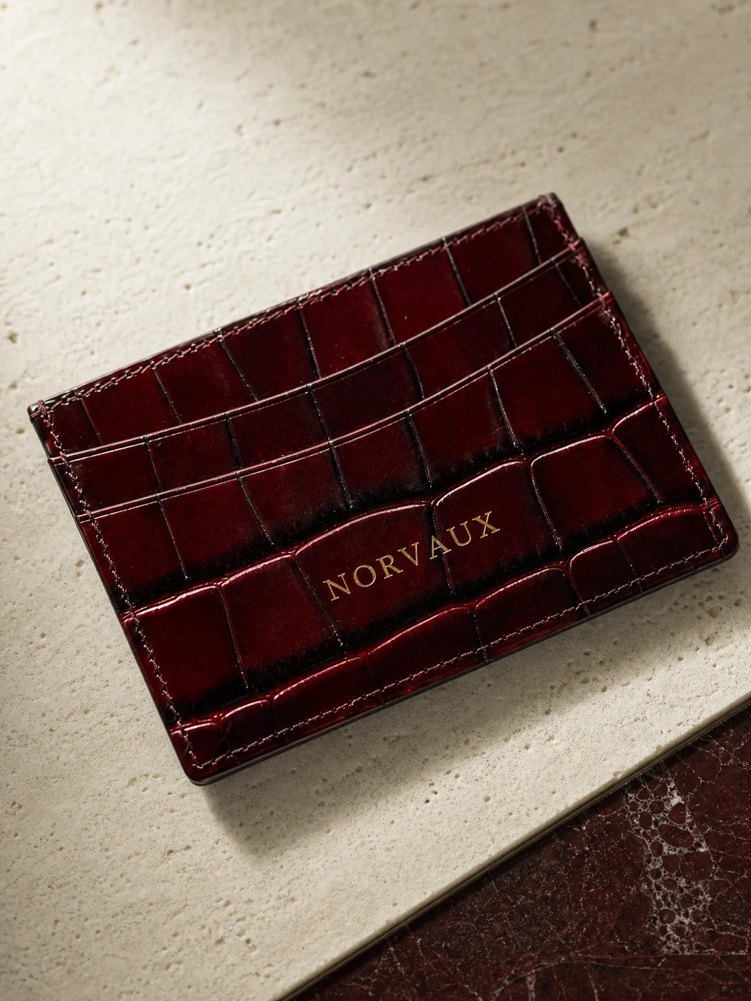 Macro detail of CROVÉ Rubis crocodile-embossed calf leather and stitching