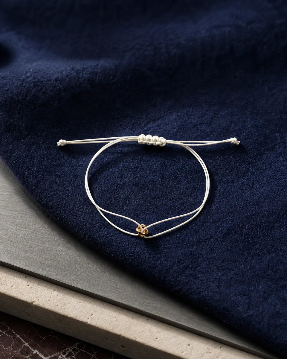 ORÉA Blanc ivory cord bracelet with a polished gold-tone bead