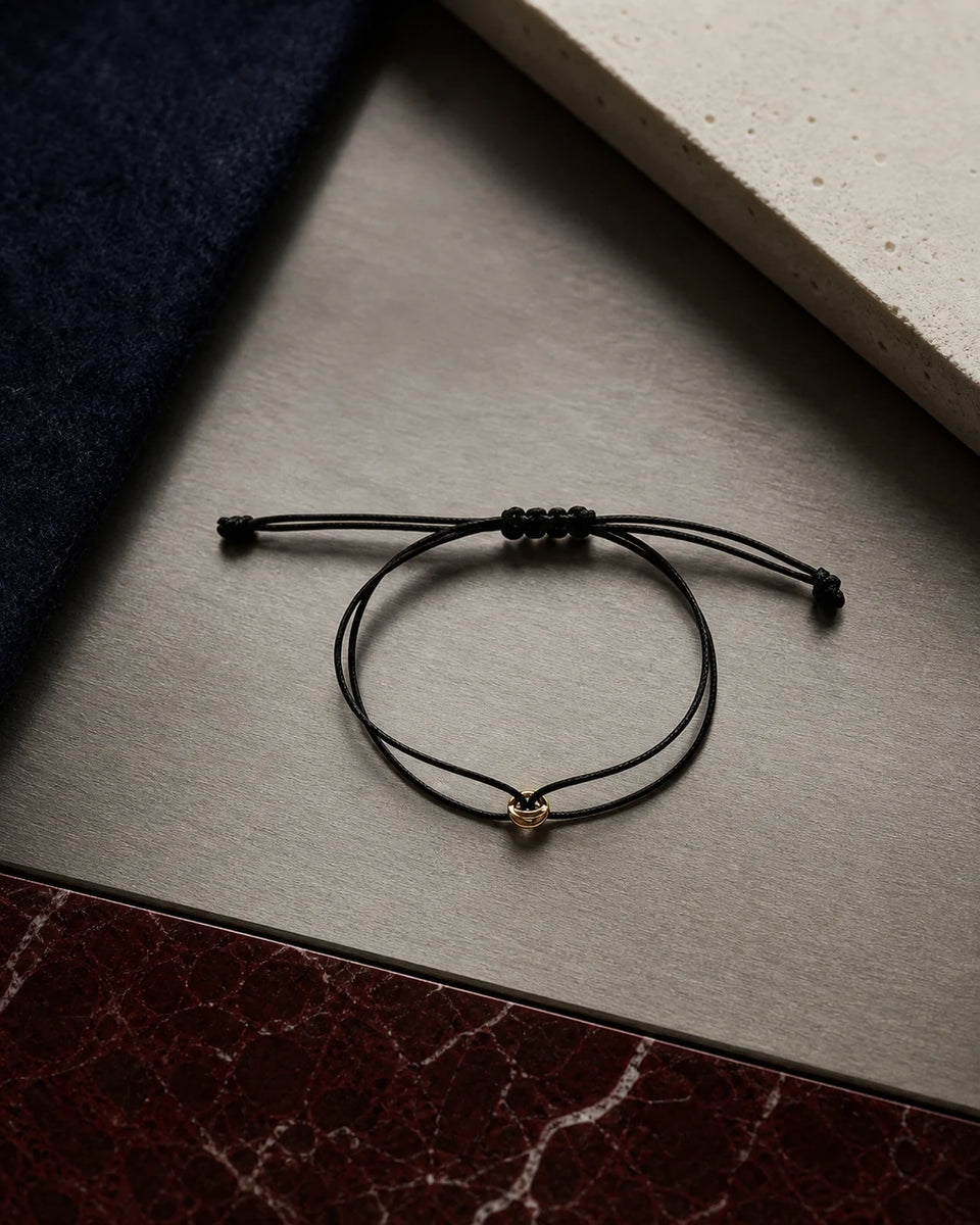 ORÉA Noir black cord bracelet with a polished gold-tone bead