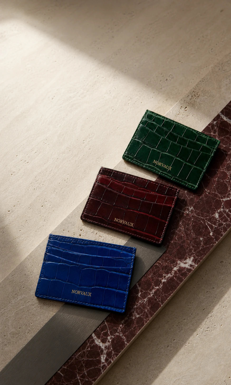NORVAUX cardholders in ocean blue, ruby and emerald crocodile-embossed calf